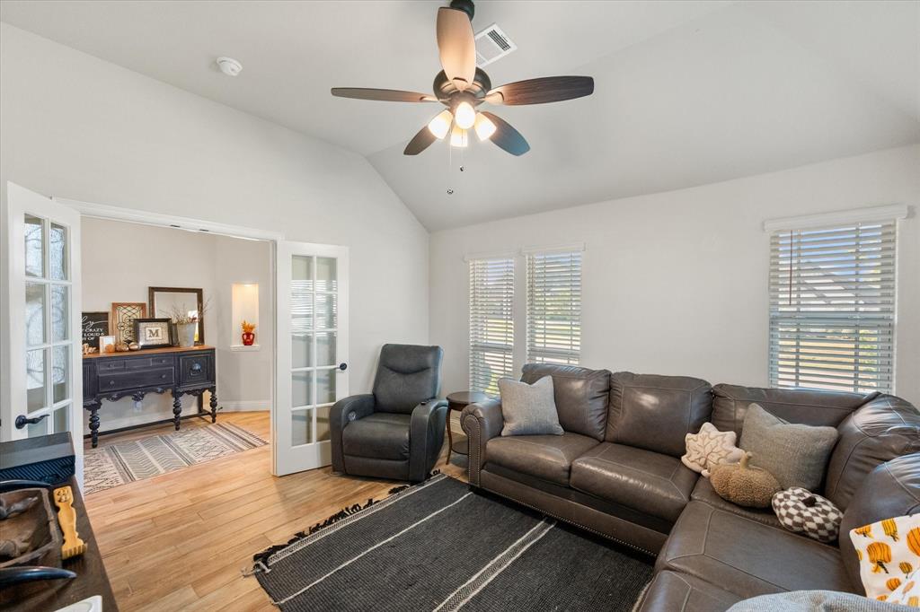 4021 Grove Valley Road Midlothian, TX 76065 - Photo 12 of 27 Main Living room featuring lofted ceiling, wood finished floors, healthy amount of natural light, and a ceiling fan