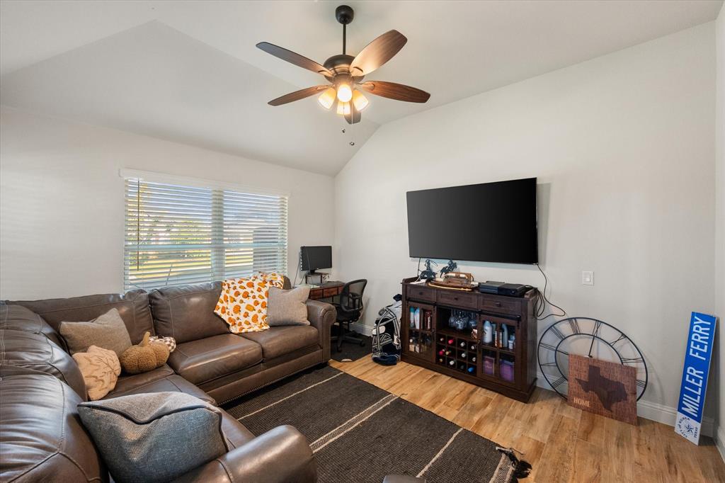 4021 Grove Valley Road Midlothian, TX 76065 - Photo 13 of 27 Main Living room featuring light wood-style flooring, lofted ceiling, and a ceiling fan