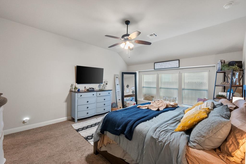 4021 Grove Valley Road Midlothian, TX 76065 - Photo 20 of 27 Carpeted bedroom featuring vaulted ceiling and a ceiling fan
