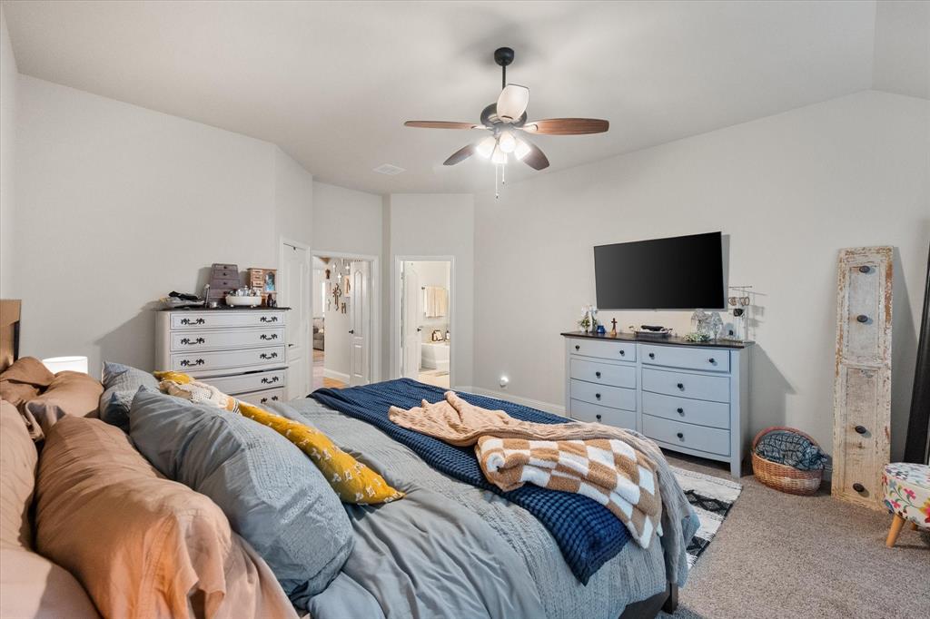 4021 Grove Valley Road Midlothian, TX 76065 - Photo 22 of 27 Carpeted bedroom featuring a ceiling fan and ensuite bathroom