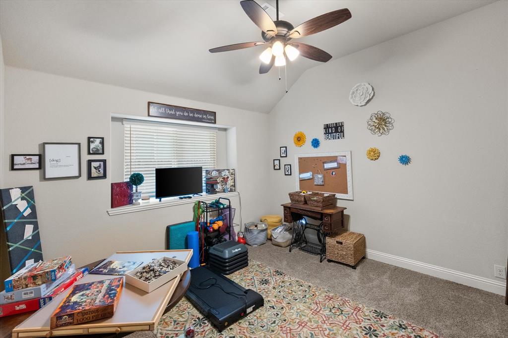 4021 Grove Valley Road Midlothian, TX 76065 - Photo 23 of 27 Carpeted office with vaulted ceiling and a ceiling fan