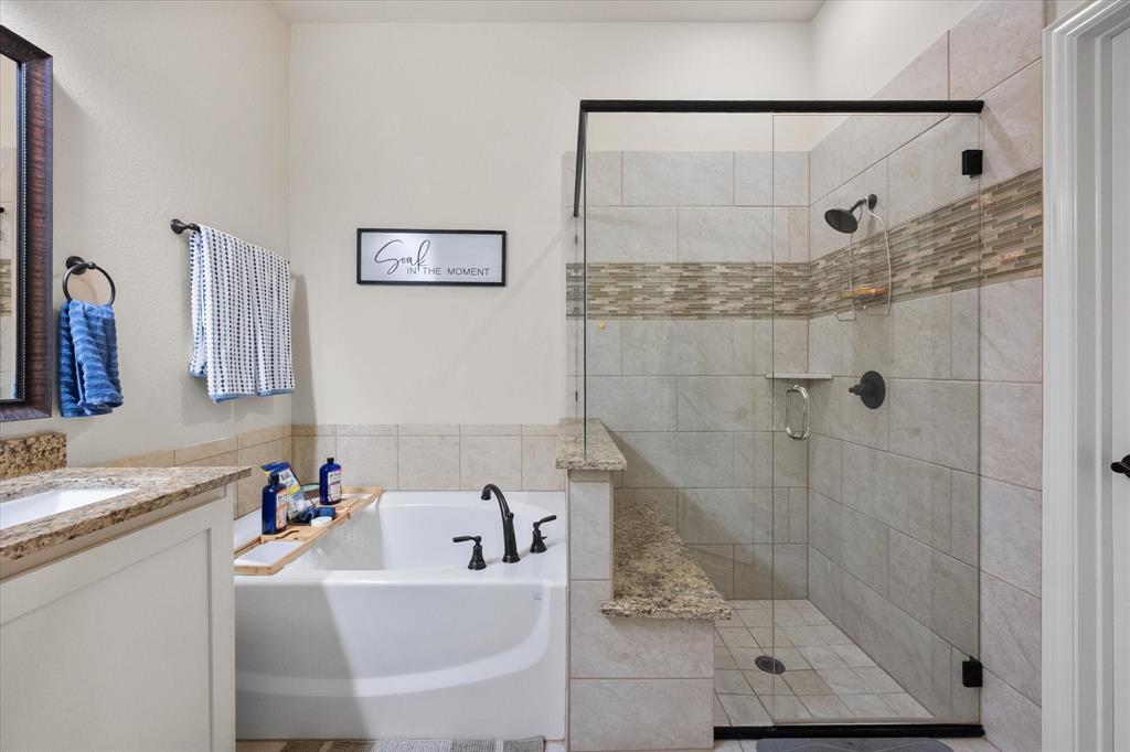 4021 Grove Valley Road Midlothian, TX 76065 - Photo 26 of 27 Bathroom with a garden tub, a shower stall, and vanity