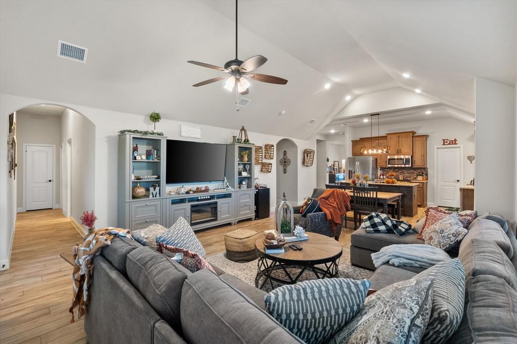 4021 Grove Valley Road Midlothian, TX 76065 - Photo 4 of 27 Main Living area featuring arched walkways, light wood finished floors, lofted ceiling, ceiling fan, and recessed lighting
