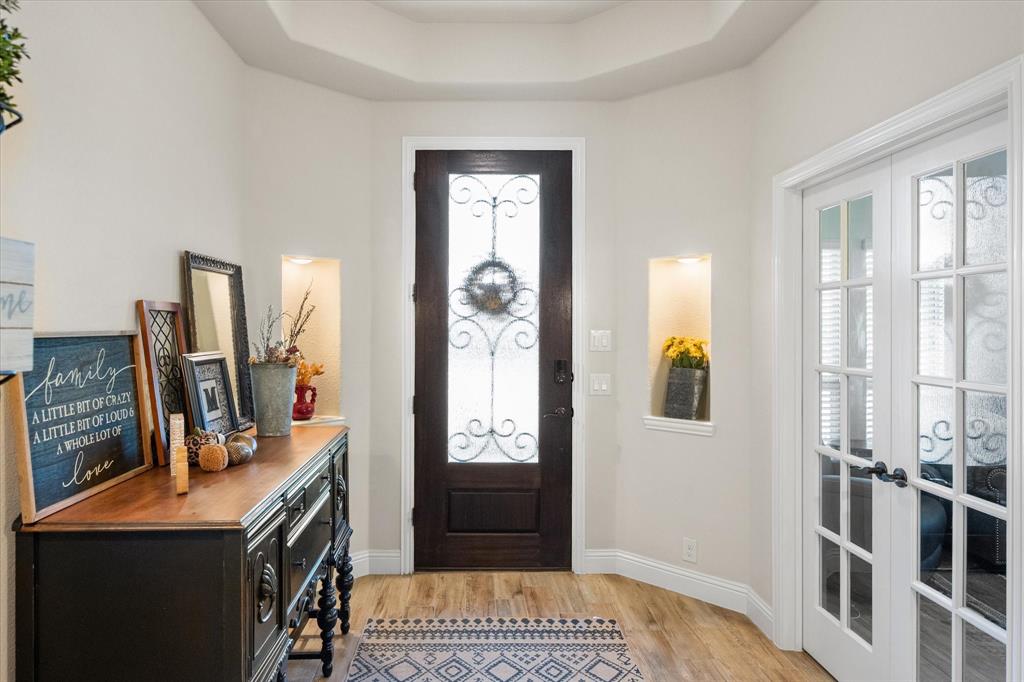 4021 Grove Valley Road Midlothian, TX 76065 - Photo 10 of 27 Entrance foyer featuring light wood finished floors, plenty of natural light, and a raised ceiling