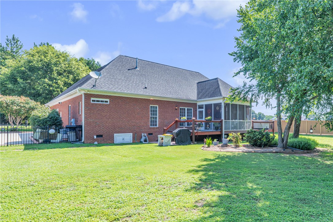 648 Mountain View Road Williamston, SC 29697 - Photo 32 of 42 A spacious backyard unfolds with a broad deck and an enclosed porch for outdoor living.
