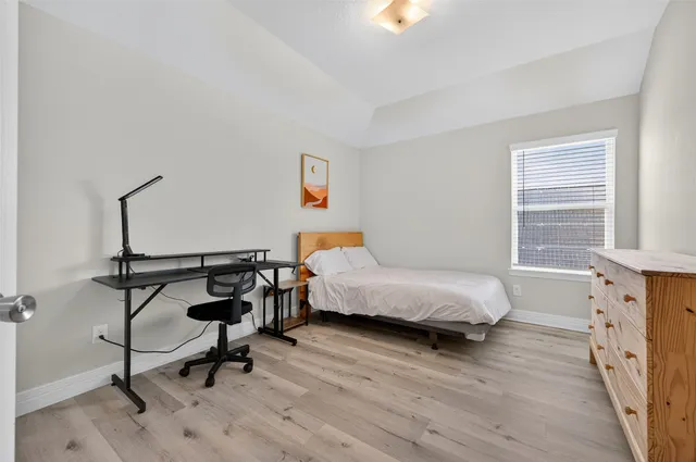 a bedroom with a bed and a table