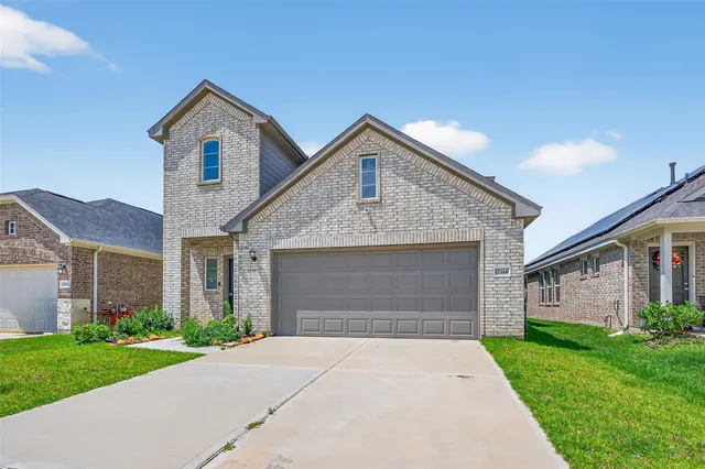 a front view of a house with a yard and garage