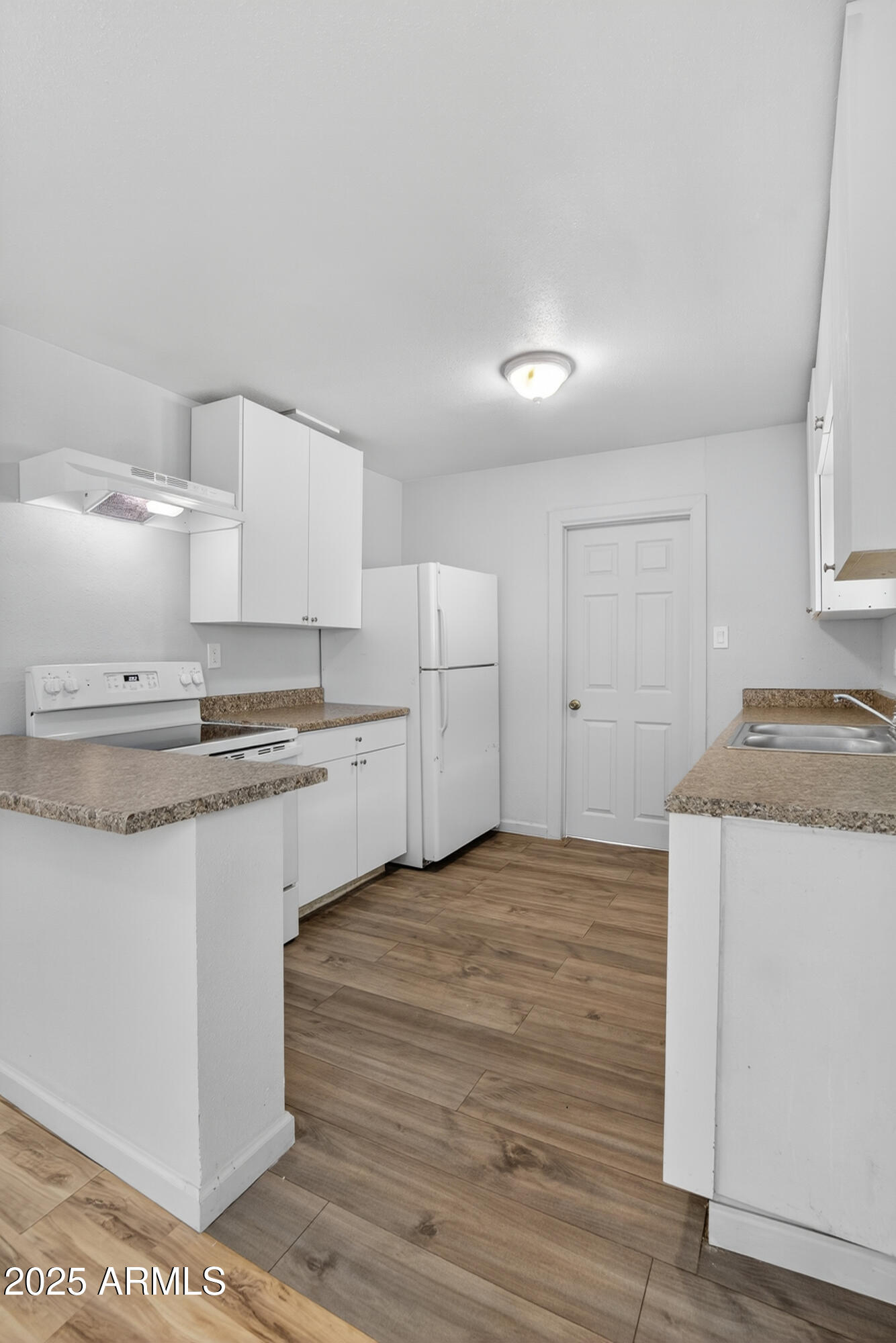 1410 South 24th Avenue, Unit A Phoenix, AZ 85009 - Photo 12 of 36 a view of a kitchen with white cabinets