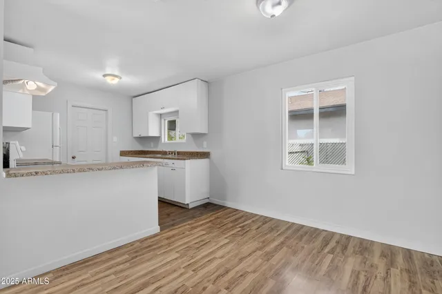 a view of kitchen with granite countertop cabinets and sink