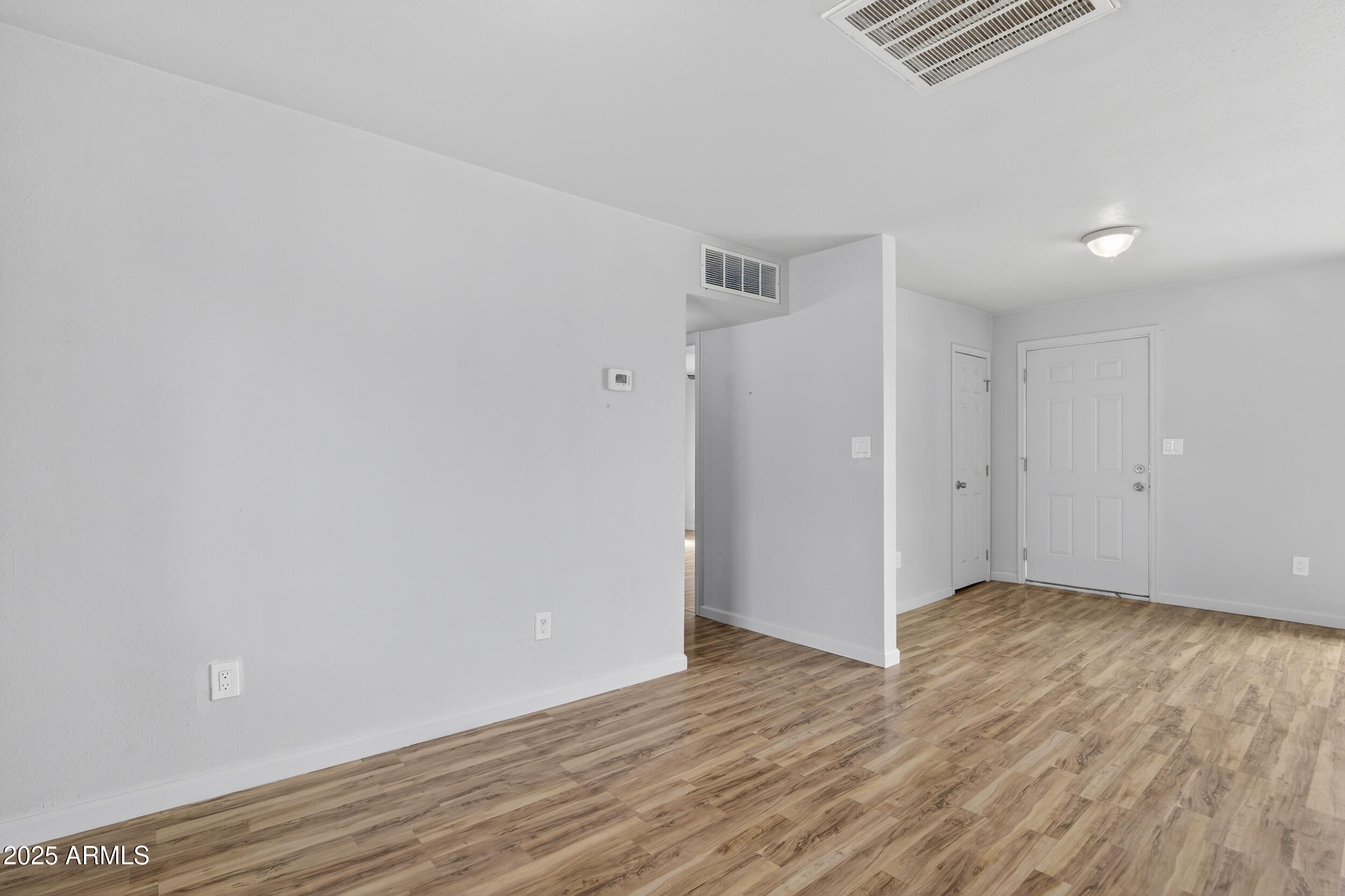 1410 South 24th Avenue, Unit A Phoenix, AZ 85009 - Photo 19 of 36 a view of an empty room with wooden floor