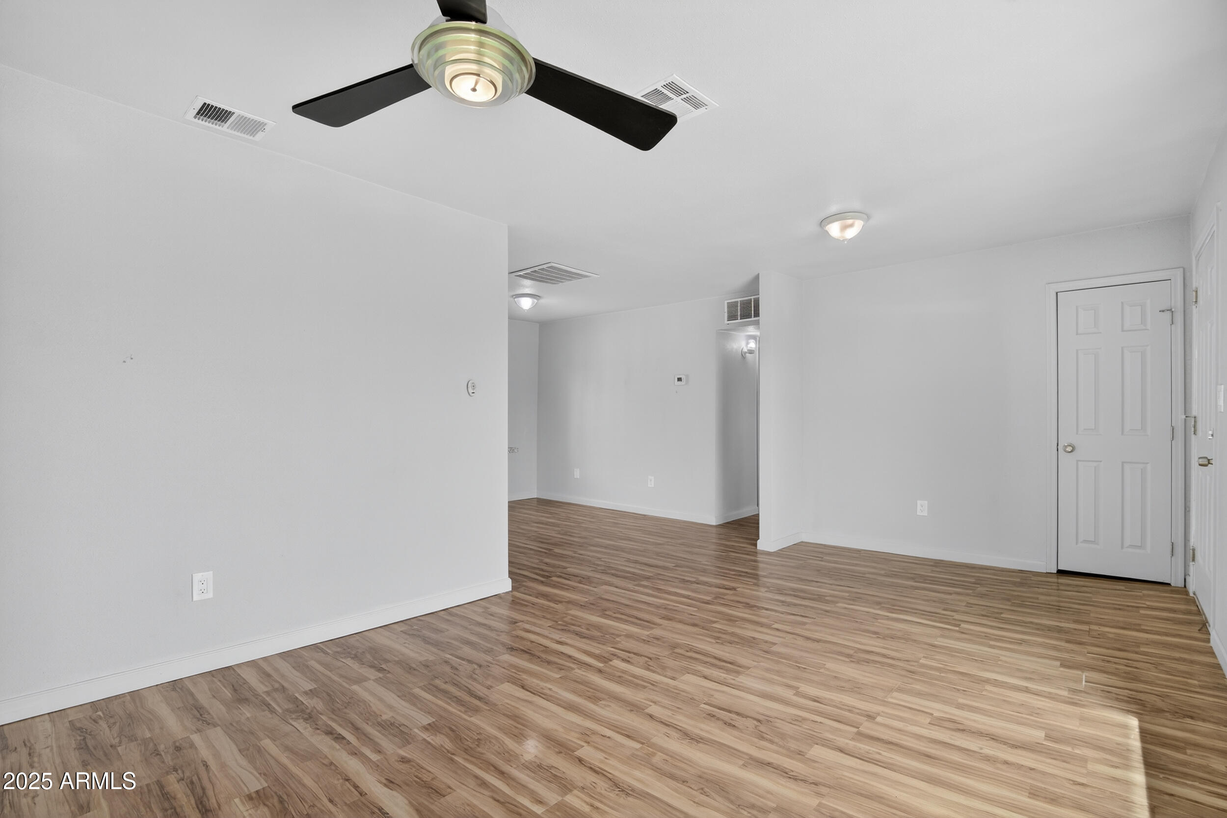 1410 South 24th Avenue, Unit A Phoenix, AZ 85009 - Photo 20 of 36 a view of an empty room with wooden floor