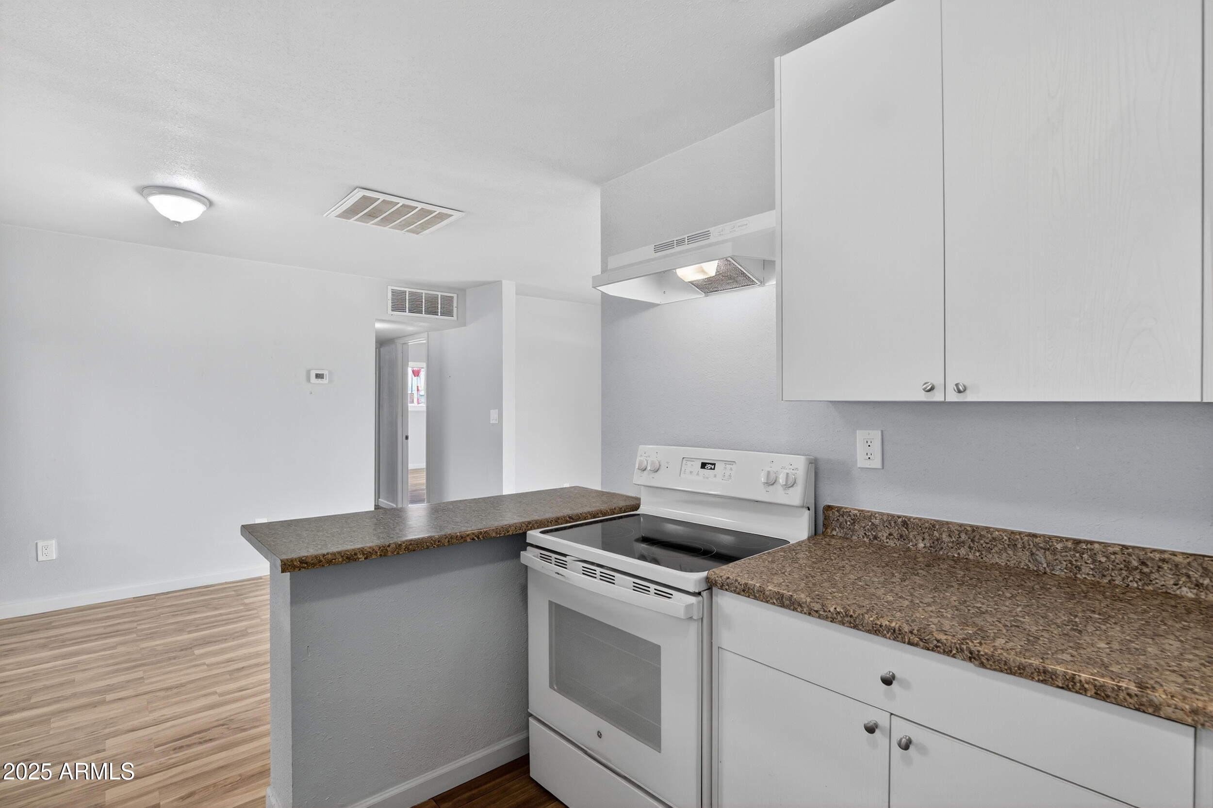 1410 South 24th Avenue, Unit A Phoenix, AZ 85009 - Photo 2 of 36 a kitchen with granite countertop white cabinets and white appliances