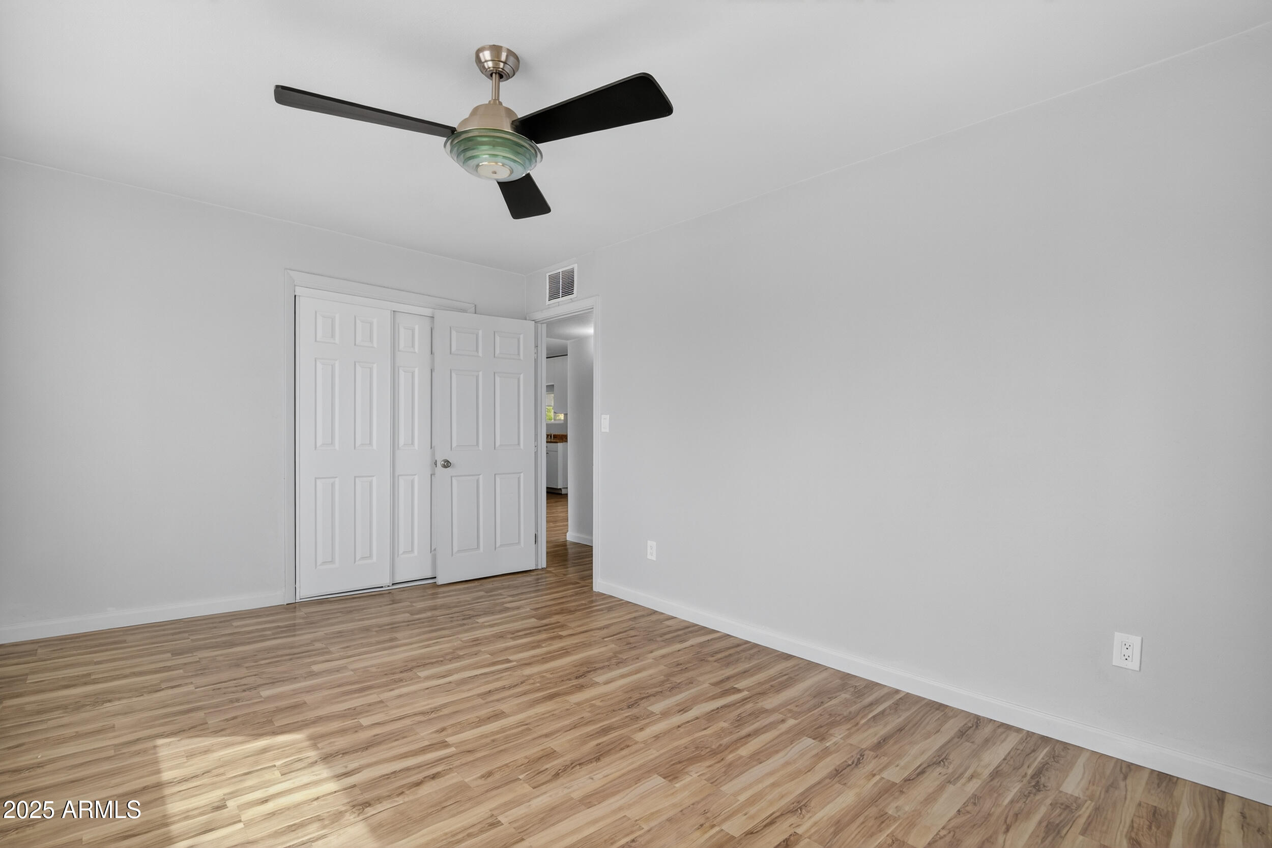 1410 South 24th Avenue, Unit A Phoenix, AZ 85009 - Photo 21 of 36 a view of empty room with wooden floor