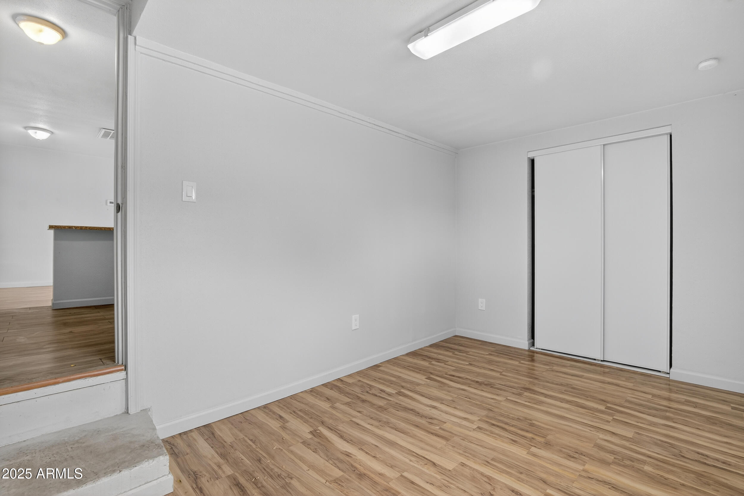 1410 South 24th Avenue, Unit A Phoenix, AZ 85009 - Photo 26 of 36 a view of empty room with wooden floor