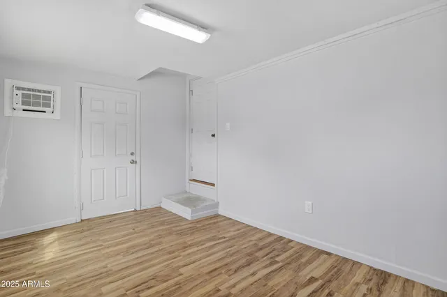 a view of empty room with wooden floor