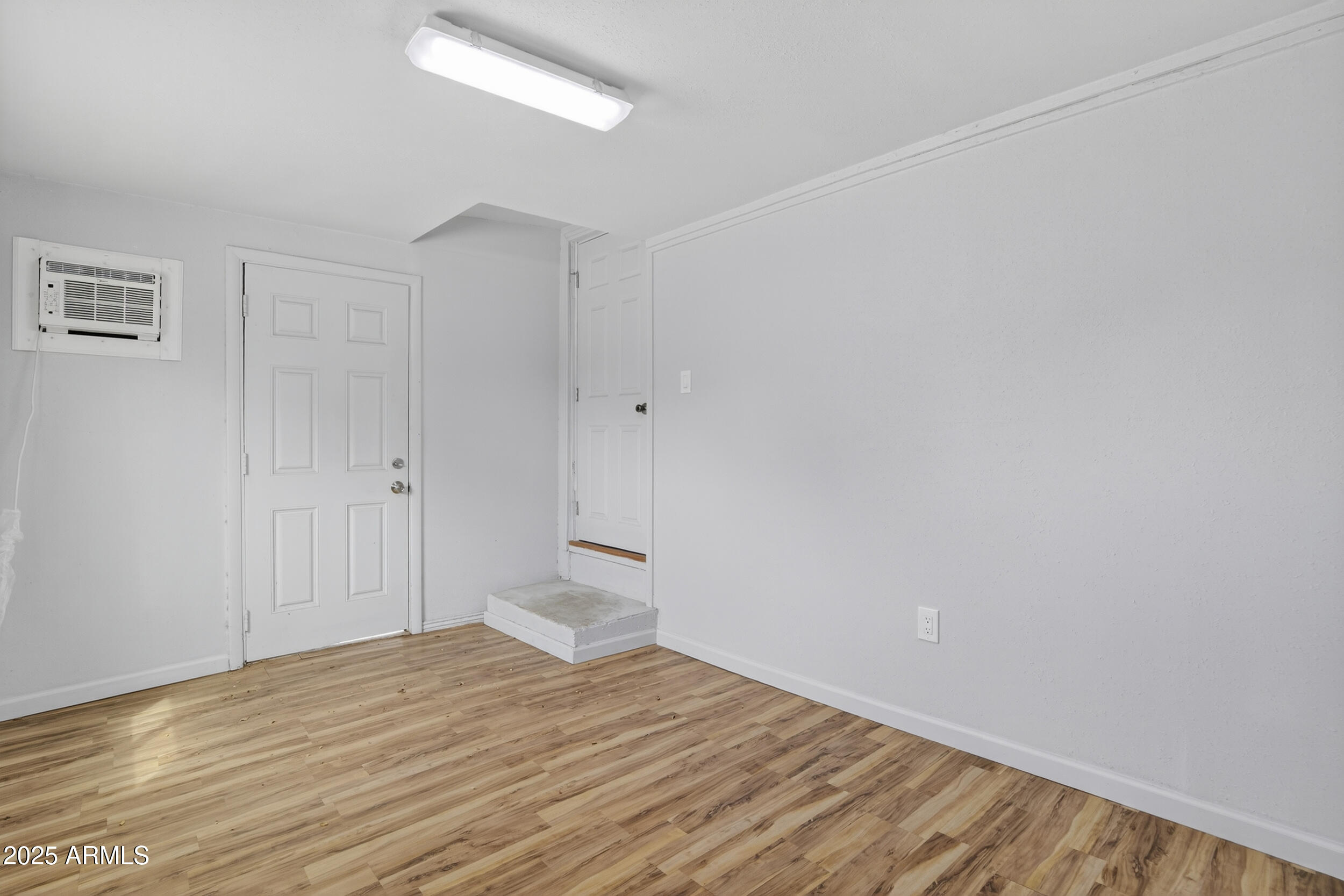 1410 South 24th Avenue, Unit A Phoenix, AZ 85009 - Photo 29 of 36 a view of empty room with wooden floor