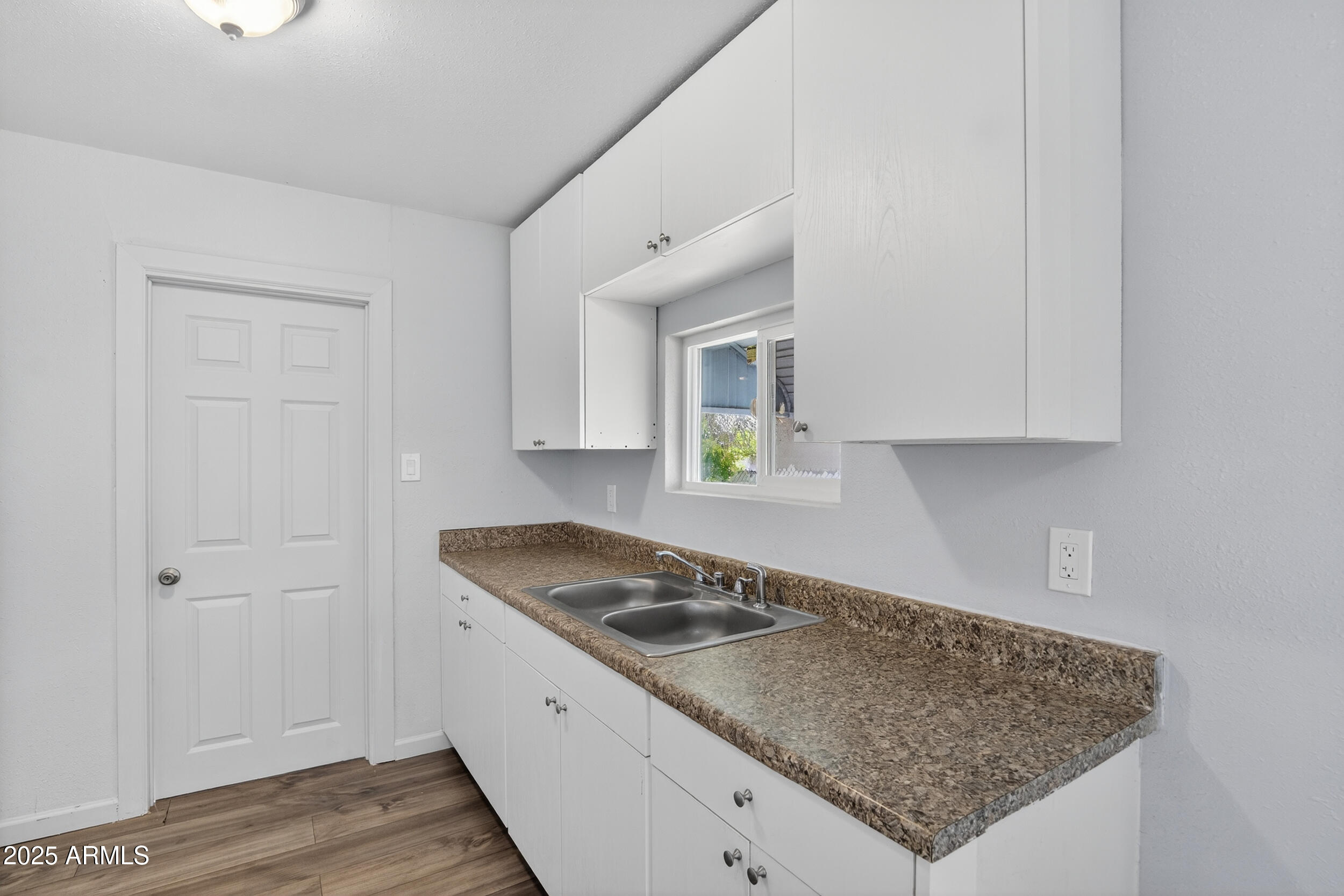 1410 South 24th Avenue, Unit A Phoenix, AZ 85009 - Photo 3 of 36 a kitchen with granite countertop white cabinets and a sink