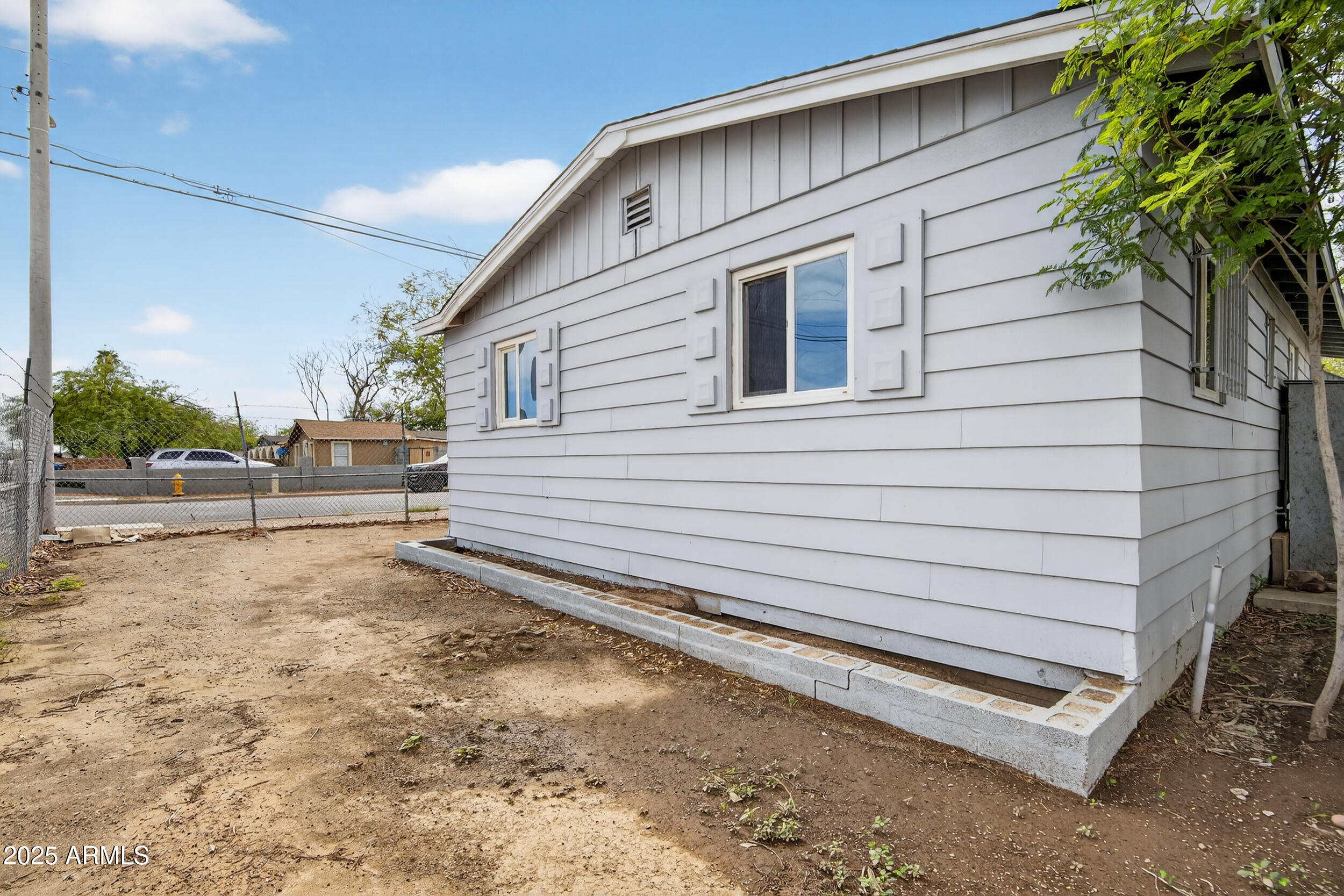 1410 South 24th Avenue, Unit A Phoenix, AZ 85009 - Photo 31 of 36 a view of a house with a yard