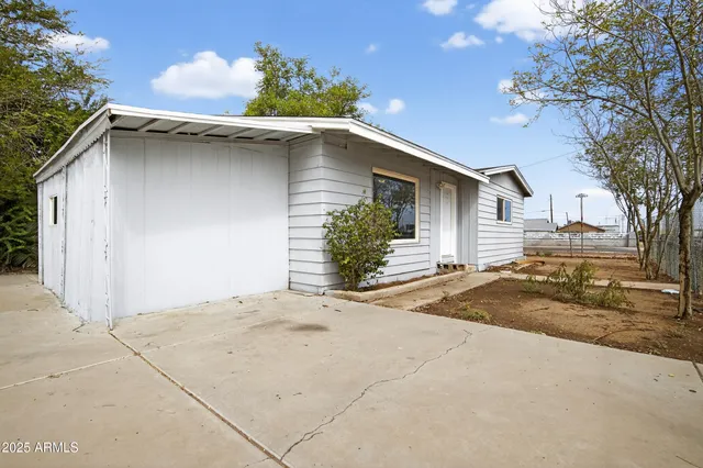 a view of a house with a yard and garage