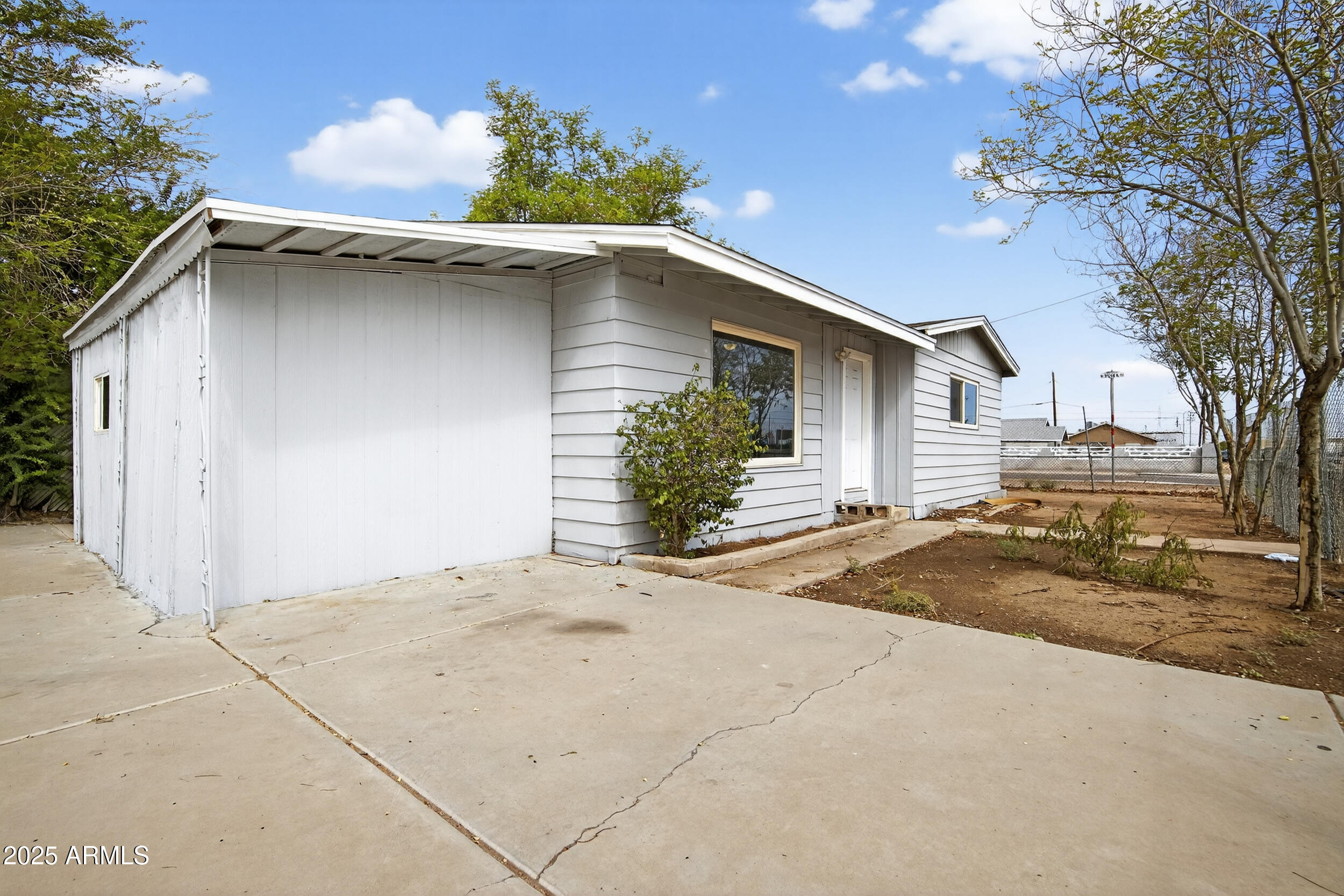 1410 South 24th Avenue, Unit A Phoenix, AZ 85009 - Photo 33 of 36 a view of a house with a yard and garage