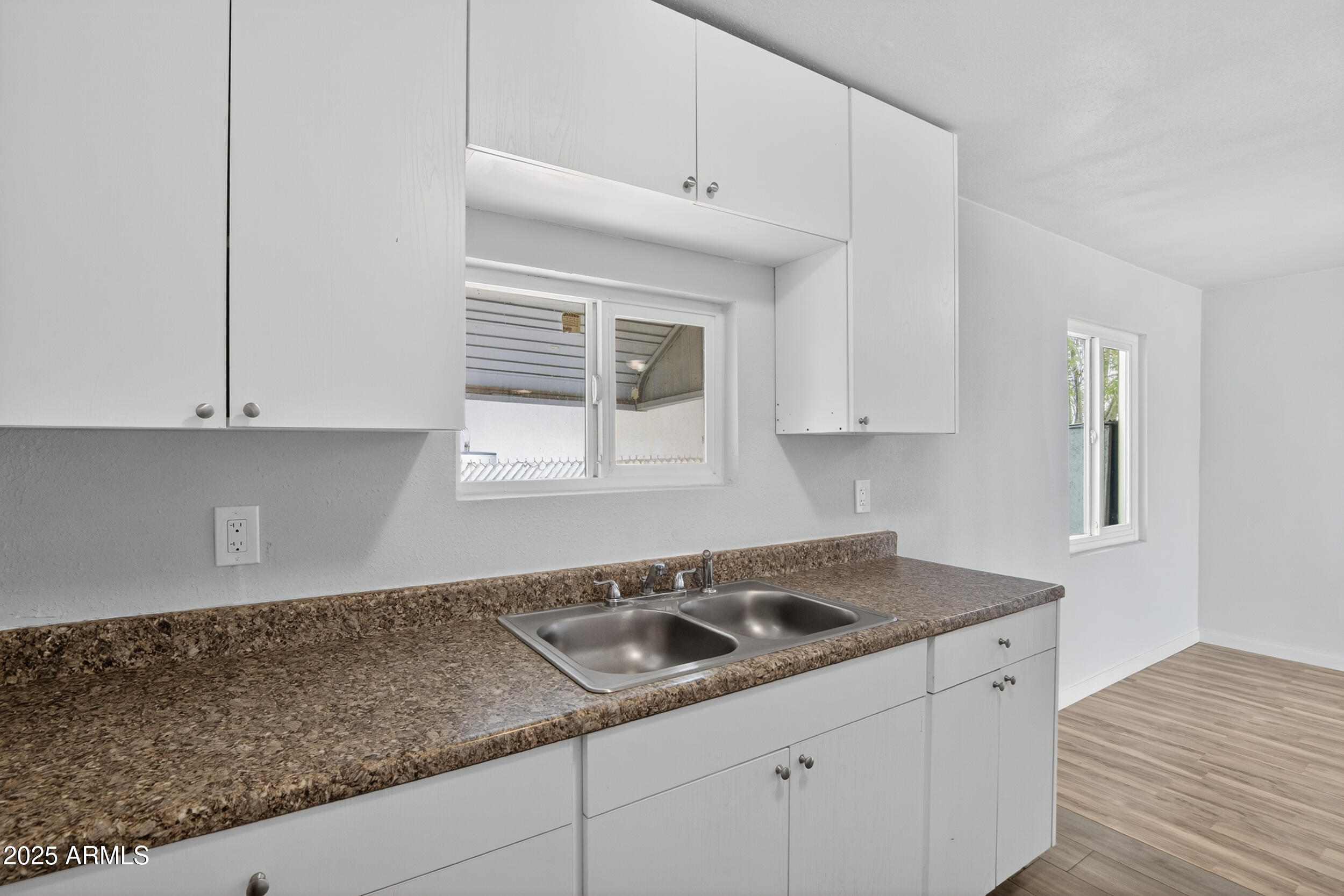 1410 South 24th Avenue, Unit A Phoenix, AZ 85009 - Photo 4 of 36 a kitchen with granite countertop white cabinets and a granite counter tops