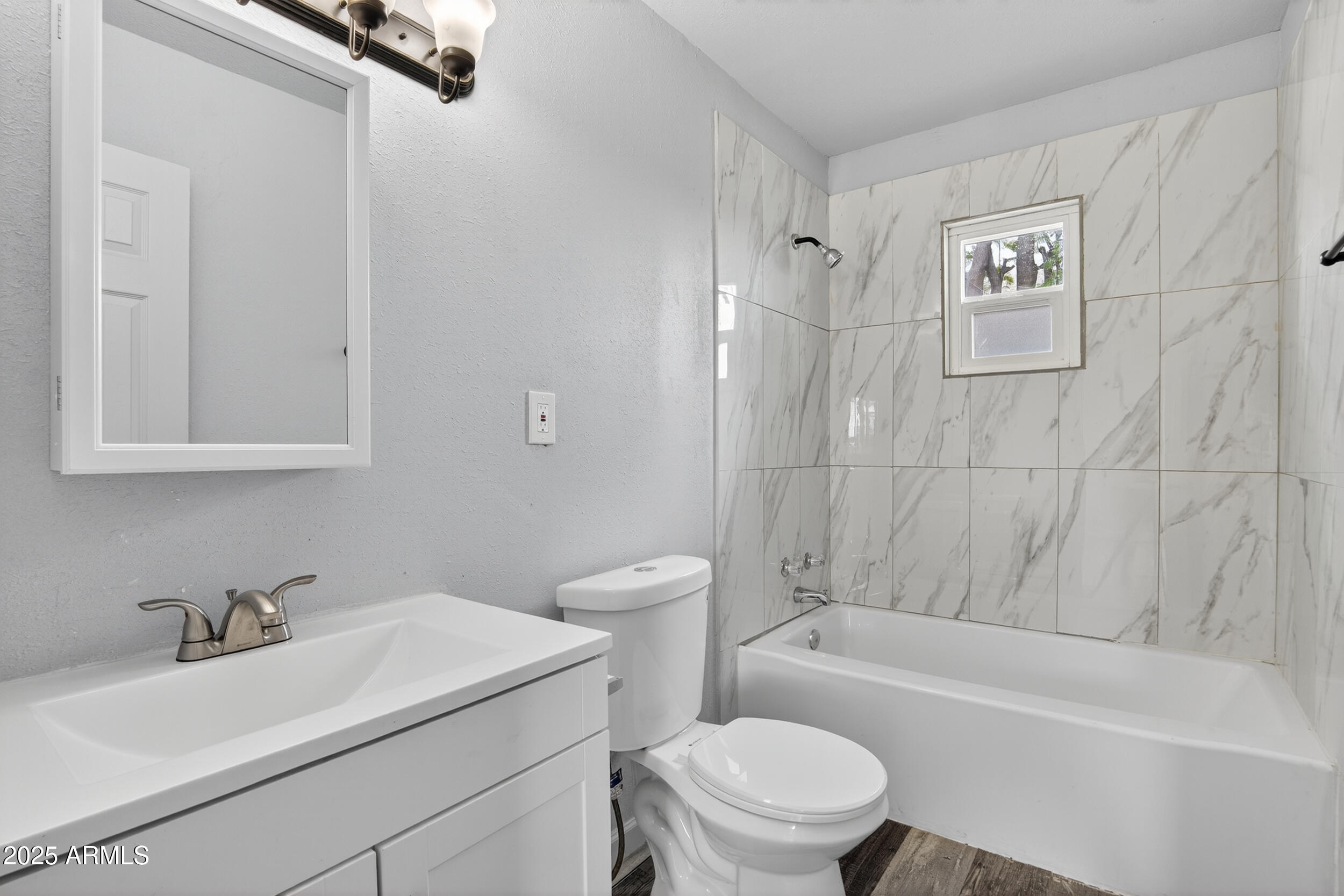 1410 South 24th Avenue, Unit A Phoenix, AZ 85009 - Photo 5 of 36 a bathroom with a sink toilet and a bathtub