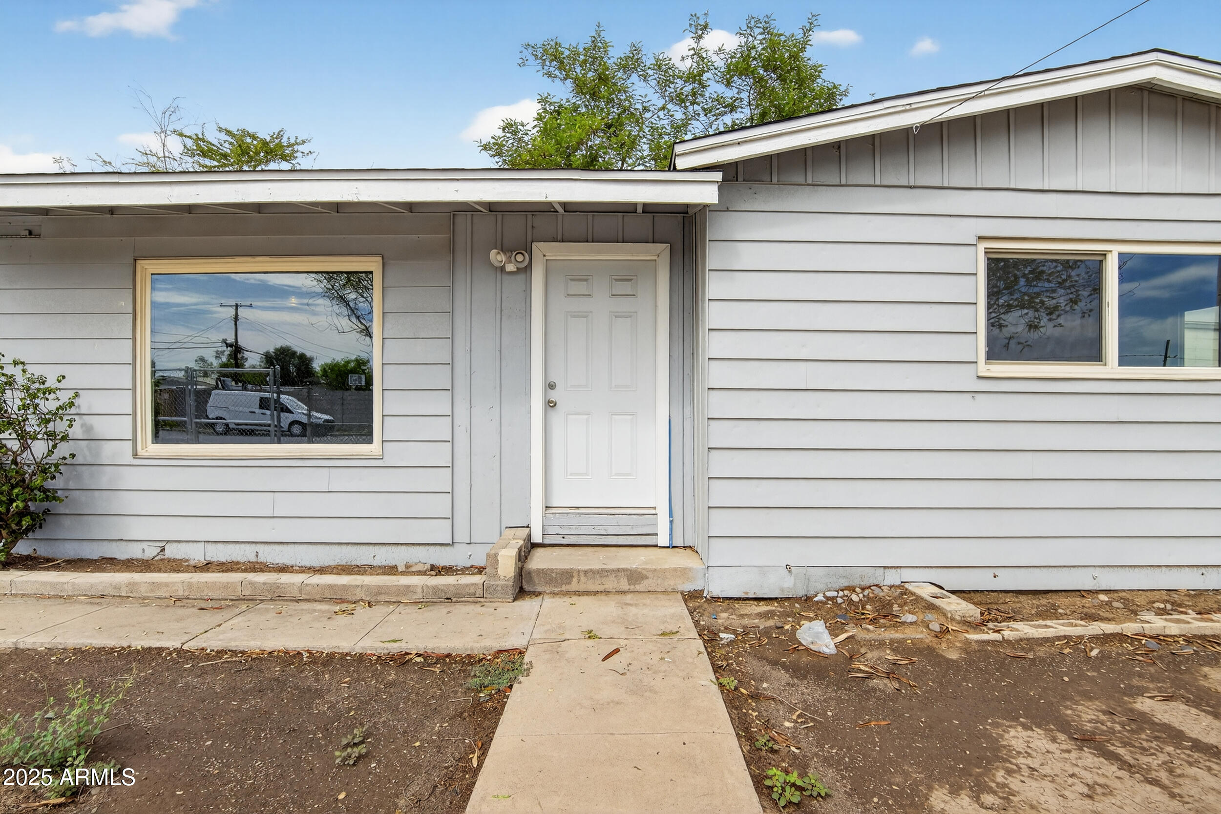 1410 South 24th Avenue, Unit A Phoenix, AZ 85009 - Photo 6 of 36 a white house with a outdoor space