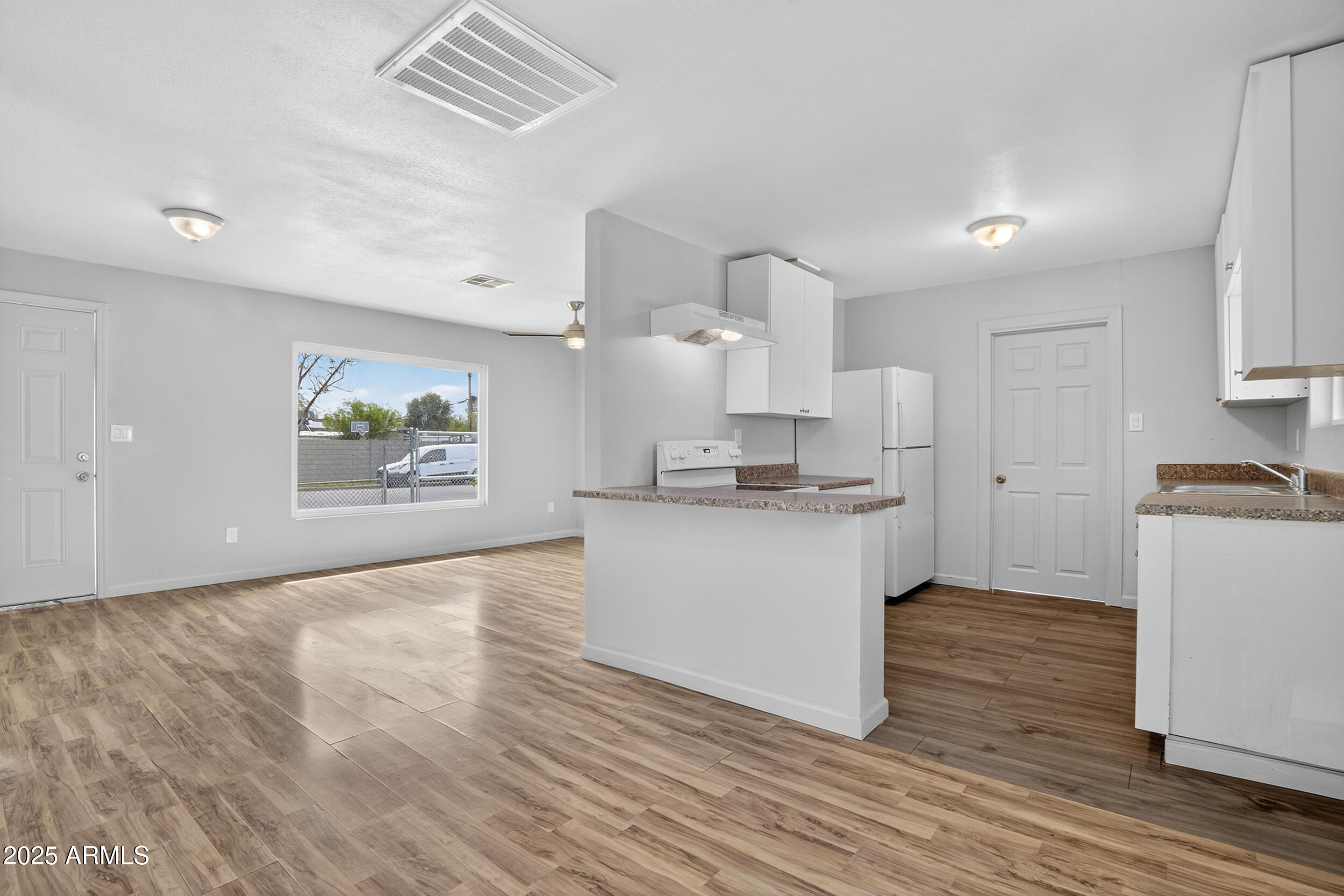 1410 South 24th Avenue, Unit A Phoenix, AZ 85009 - Photo 9 of 36 a kitchen with cabinets and wooden floor