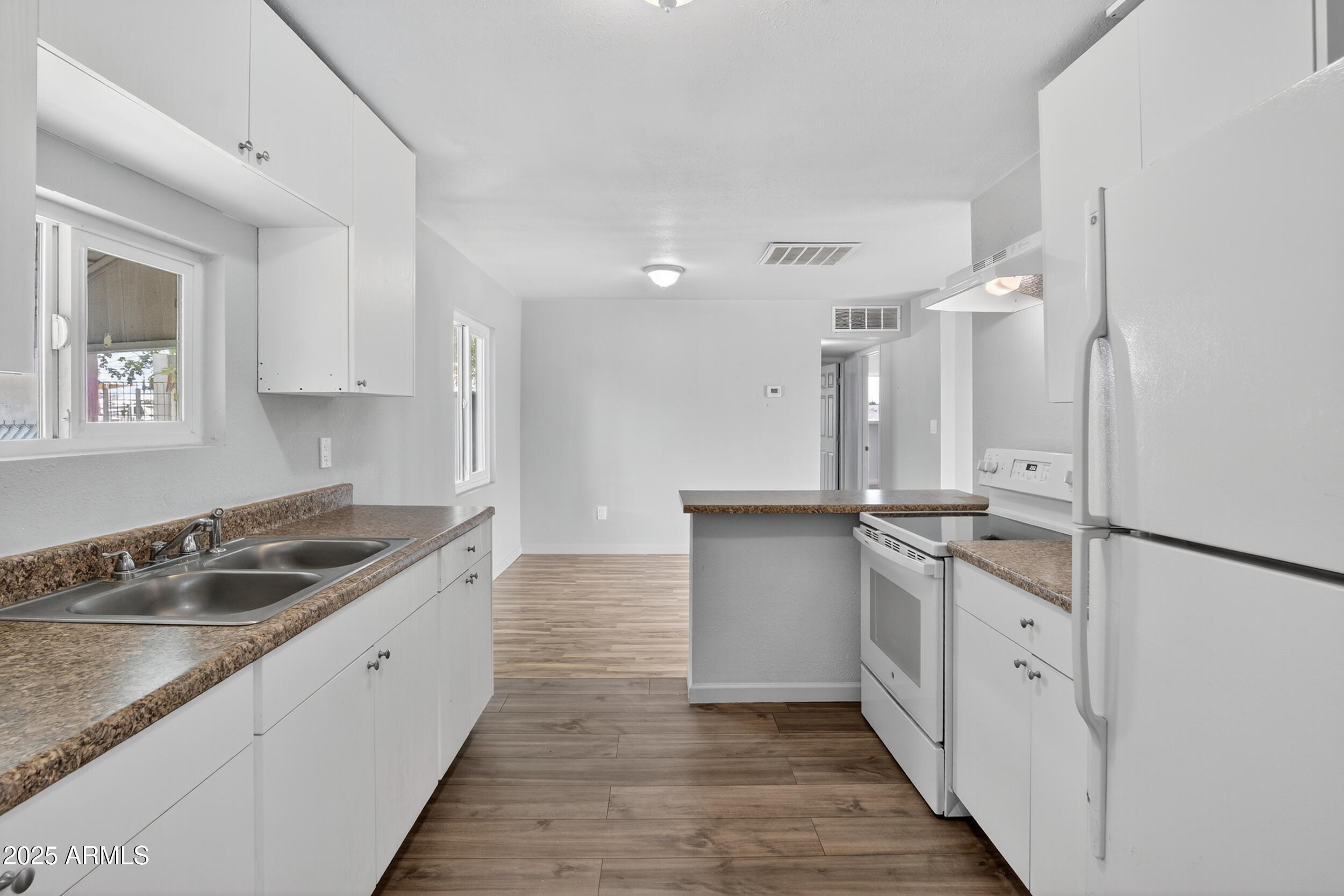 1410 South 24th Avenue, Unit A Phoenix, AZ 85009 - Photo 10 of 36 a kitchen with granite countertop a sink and cabinets