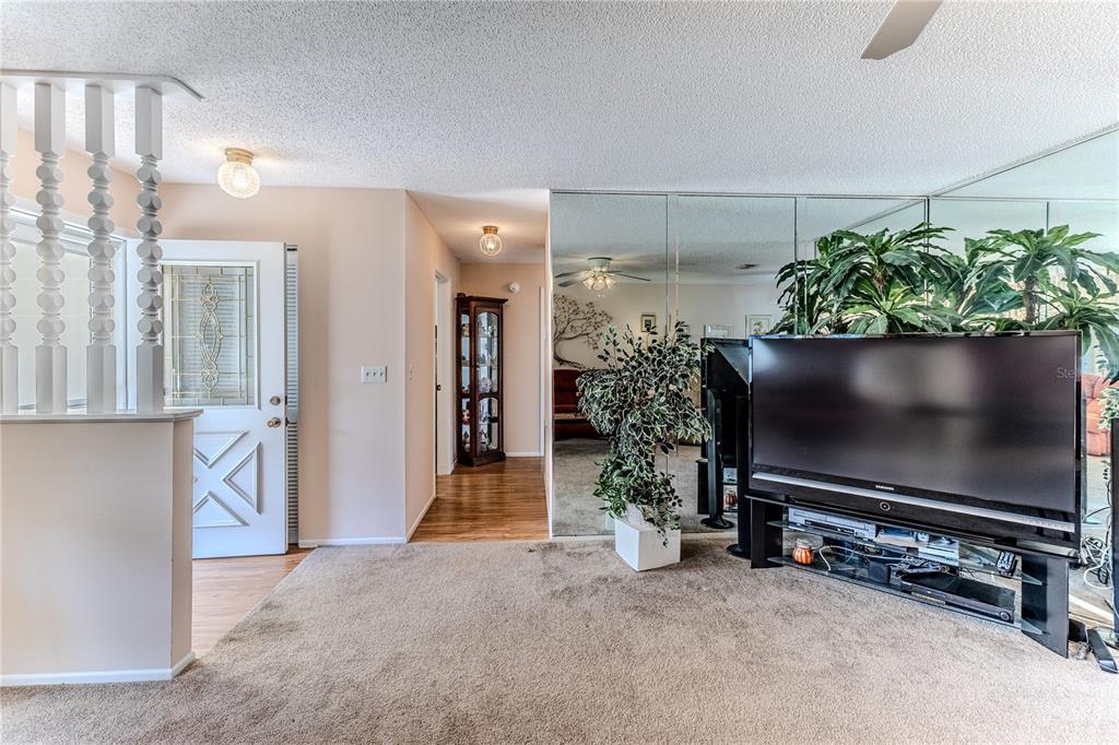 6163 Spyglass Court Spring Hill, FL 34606 - Photo 11 of 73 a room with furniture and a flat screen tv