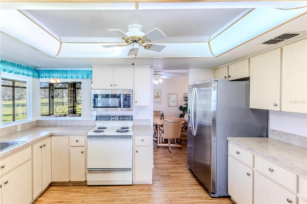 6163 Spyglass Court Spring Hill, FL 34606 - Photo 20 of 73 a kitchen with stainless steel appliances a refrigerator sink and stove