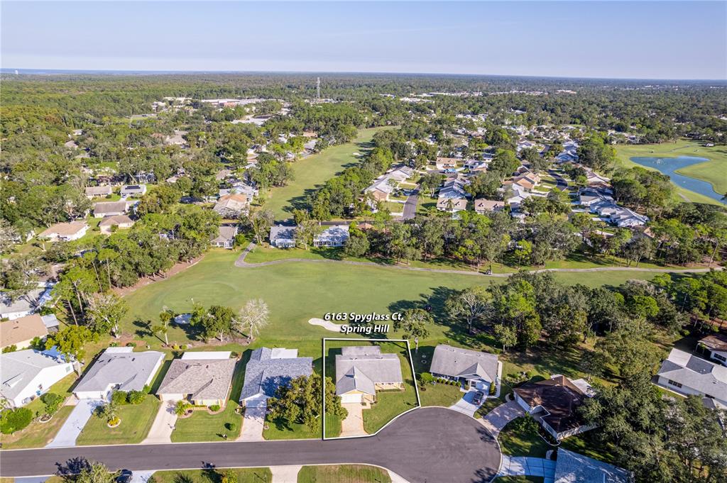 6163 Spyglass Court Spring Hill, FL 34606 - Photo 2 of 73 an aerial view of residential houses with outdoor space and swimming pool