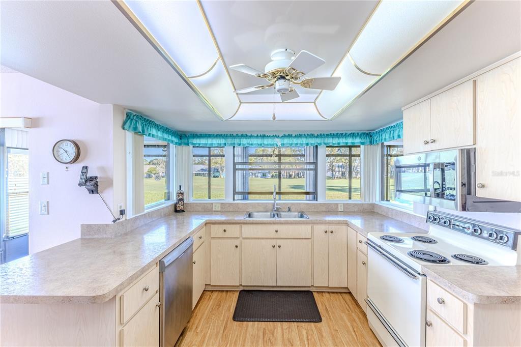 6163 Spyglass Court Spring Hill, FL 34606 - Photo 21 of 73 a kitchen with a sink stove and cabinets