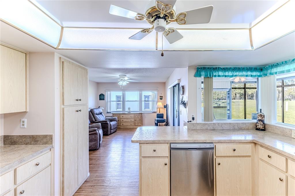 6163 Spyglass Court Spring Hill, FL 34606 - Photo 22 of 73 a kitchen with stainless steel appliances a chandelier