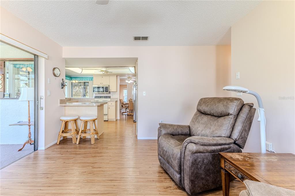 6163 Spyglass Court Spring Hill, FL 34606 - Photo 26 of 73 a living room with furniture and a wooden floor