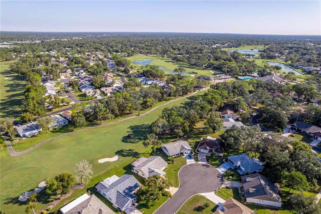 6163 Spyglass Court Spring Hill, FL 34606 - Photo 34 of 73 an aerial view of a city with lots of residential buildings ocean and mountain view in back