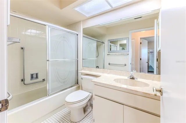 a view of a house next to a big yard and large trees