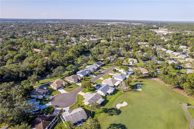 an aerial view of a house with a garden and swimming pool