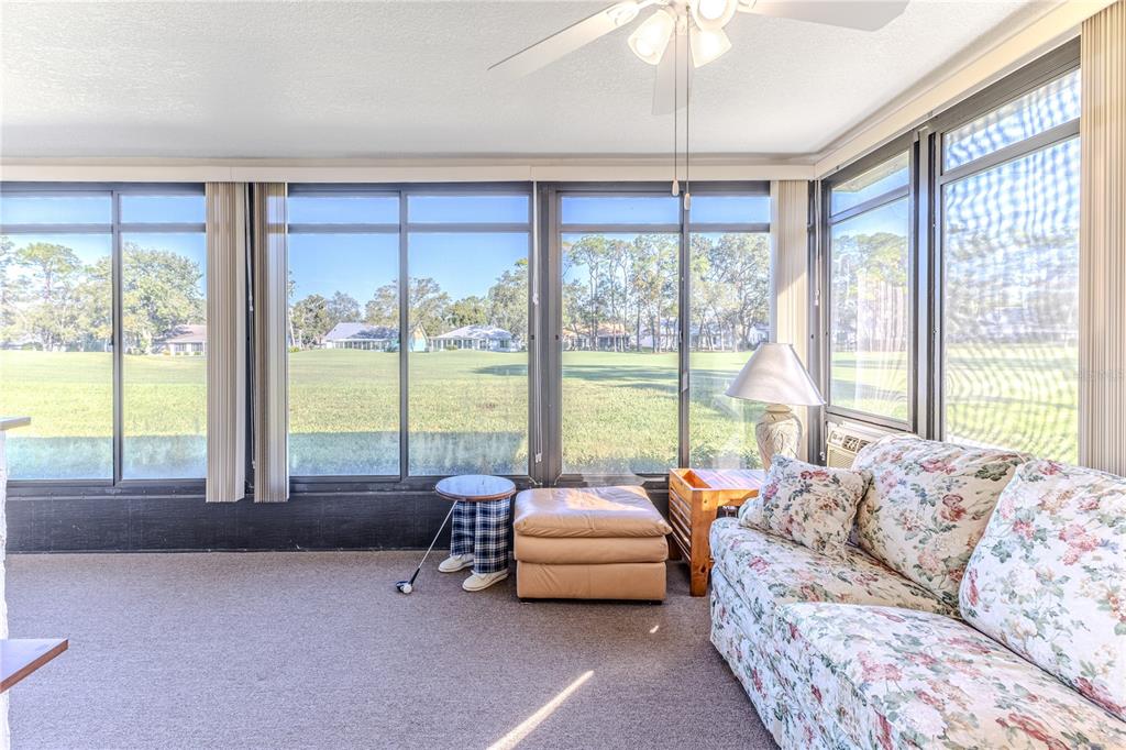 6163 Spyglass Court Spring Hill, FL 34606 - Photo 45 of 73 a living room with furniture and a large window