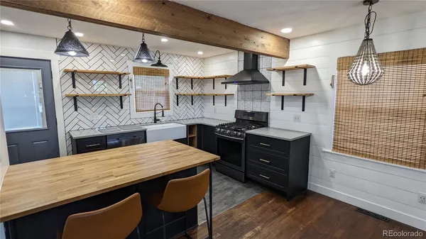 a kitchen with stainless steel appliances granite countertop a stove a sink dishwasher and a wooden cabinets