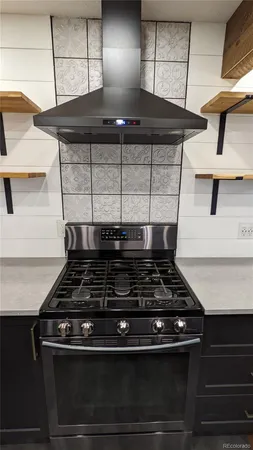 a stove top oven sitting inside of a kitchen