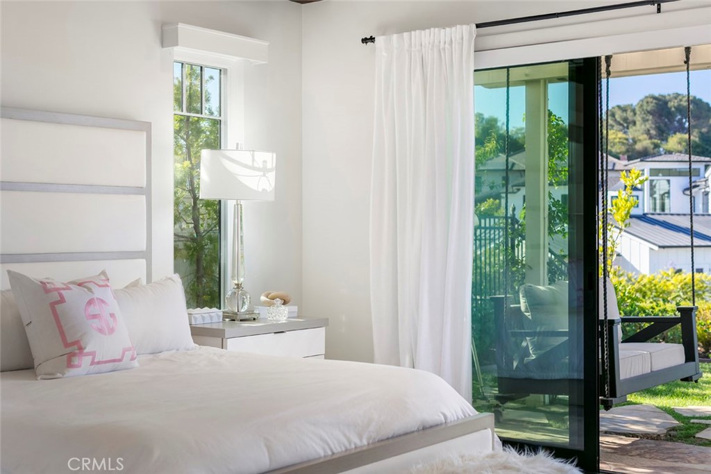 5 Rancho Elastico Road Rolling Hills Estates, CA 90274 - Photo 21 of 48 a bedroom with a large bed and a large window