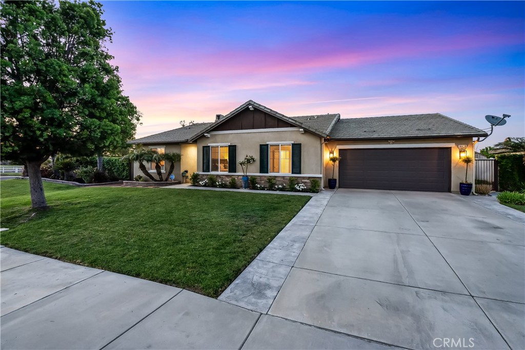 14428 Table Bluff Circle Eastvale, CA 92880 - Photo 2 of 29 a front view of a house with a yard