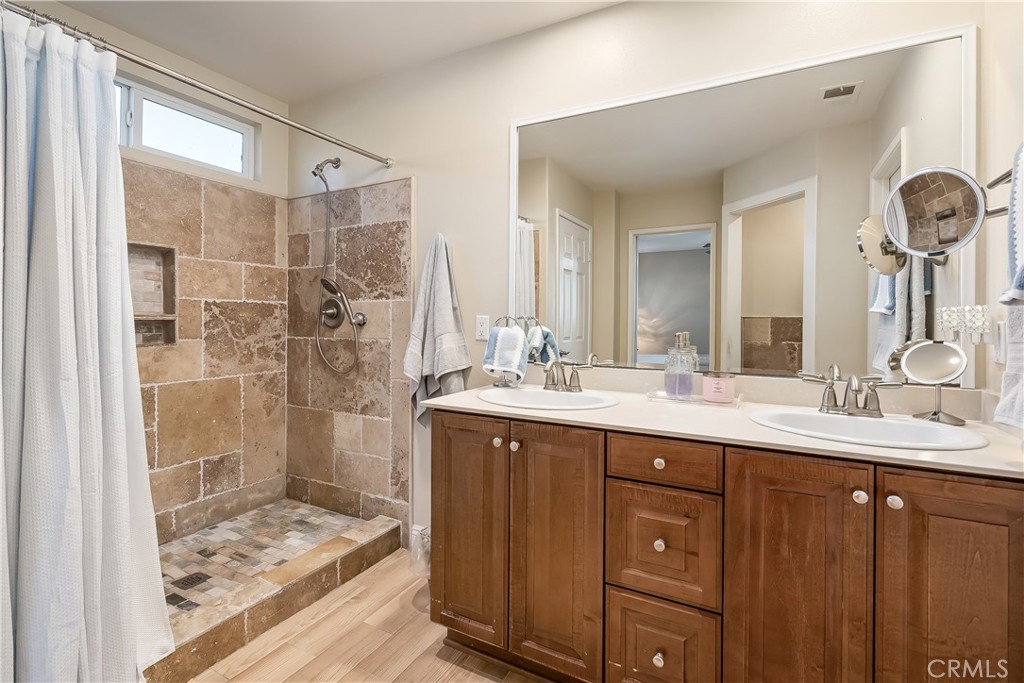 14428 Table Bluff Circle Eastvale, CA 92880 - Photo 23 of 29 a bathroom with a shower sink and mirror