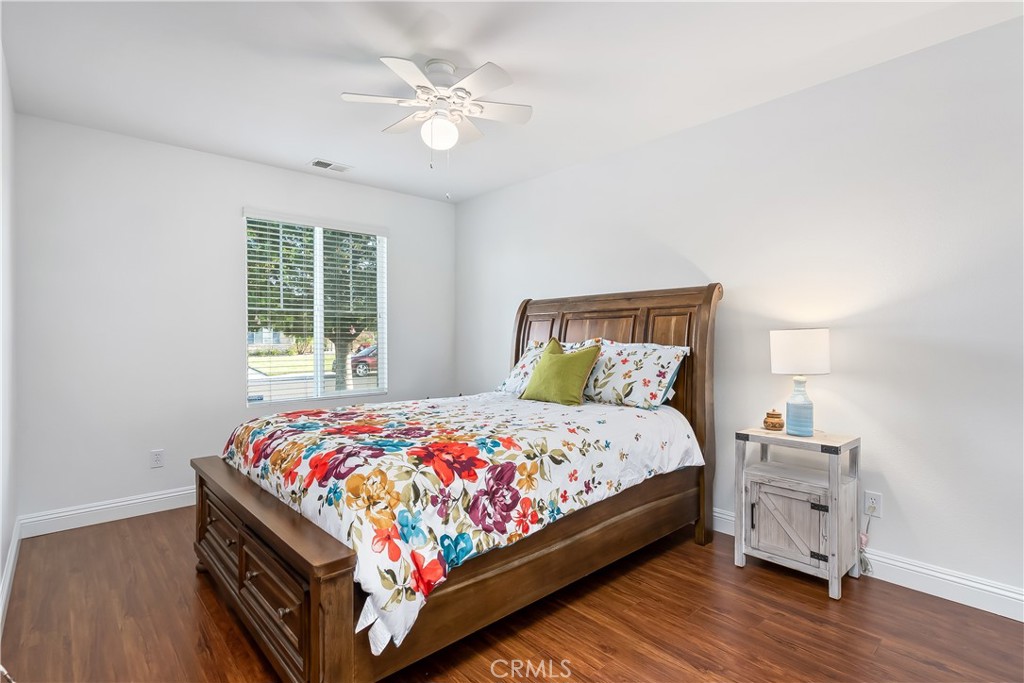 14428 Table Bluff Circle Eastvale, CA 92880 - Photo 25 of 29 a bedroom with a bed and a chandelier