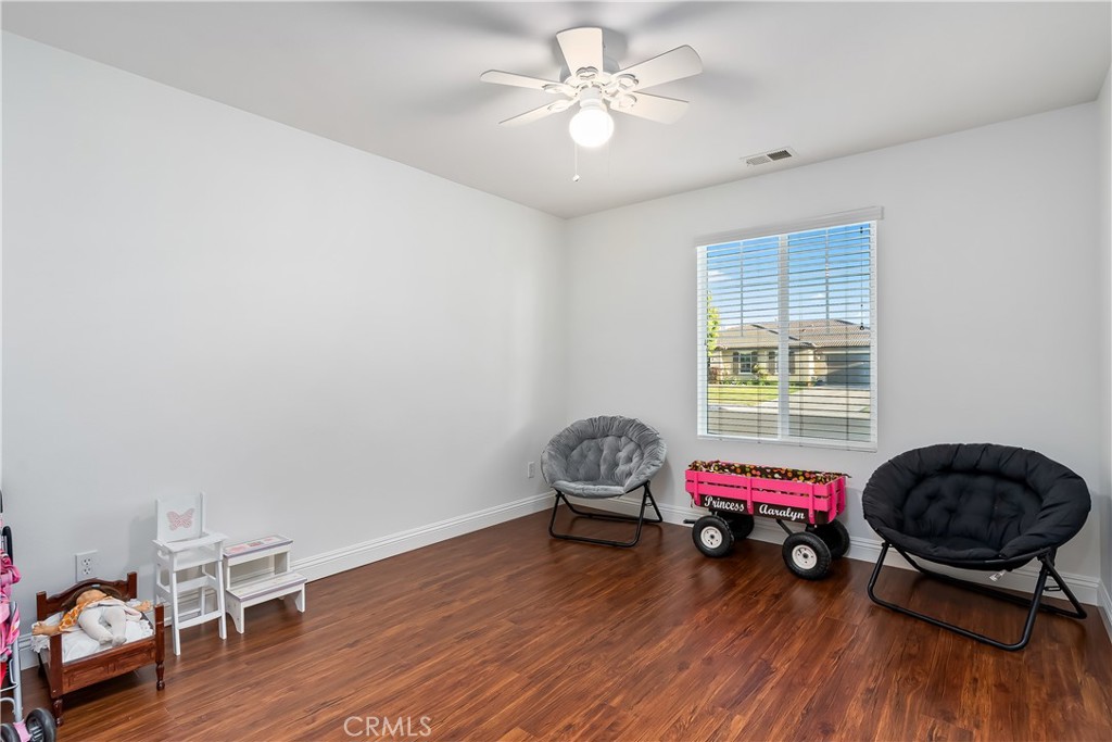 14428 Table Bluff Circle Eastvale, CA 92880 - Photo 27 of 29 a living room with furniture and a wooden floor