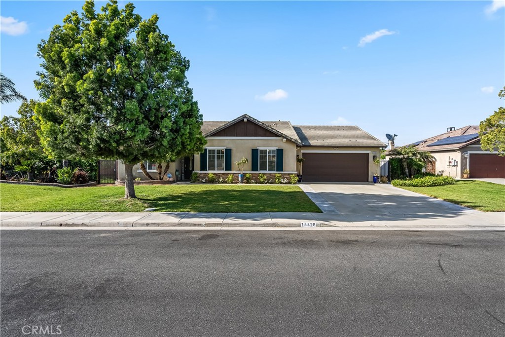 14428 Table Bluff Circle Eastvale, CA 92880 - Photo 4 of 29 a front view of a house with a yard and garage