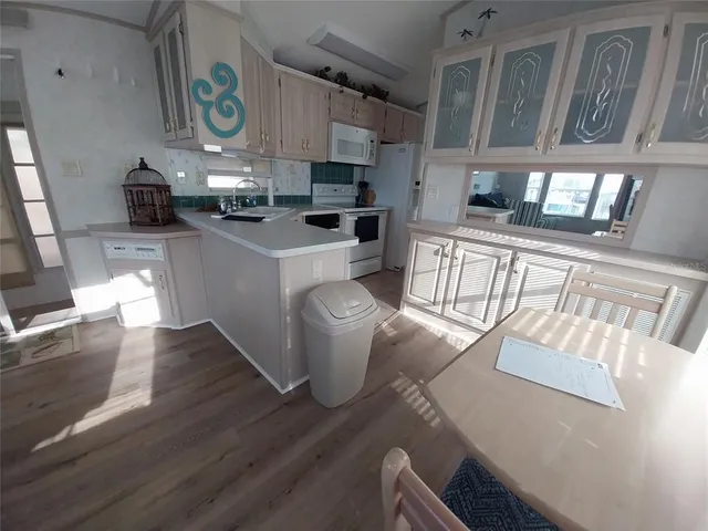 a kitchen with stainless steel appliances a refrigerator sink and cabinets