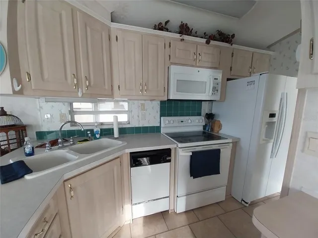 a kitchen with a sink cabinets and window