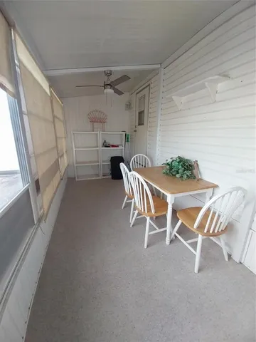 a view of a patio with table and chairs with wooden floor